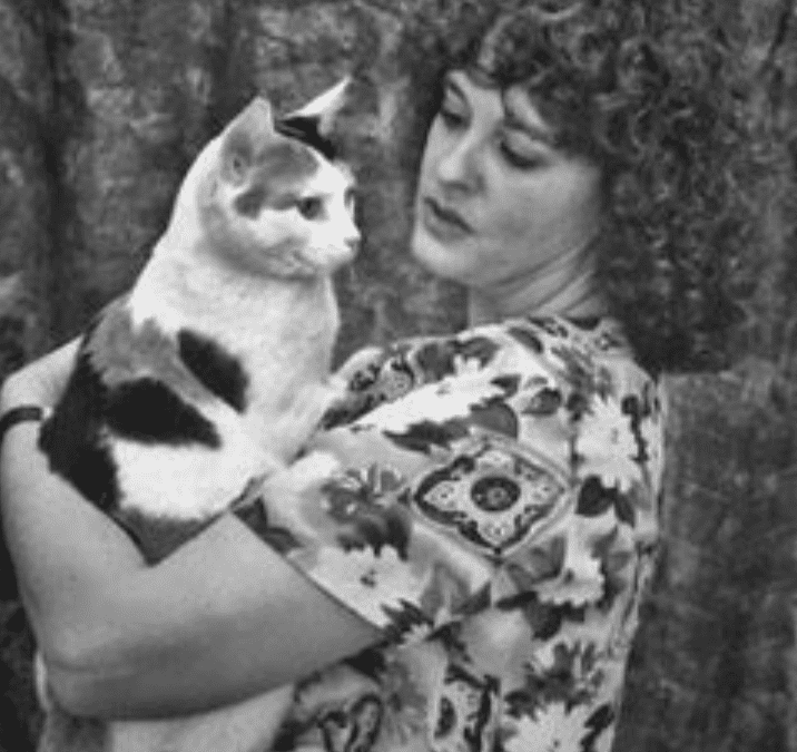 black and white photo of woman with a cat