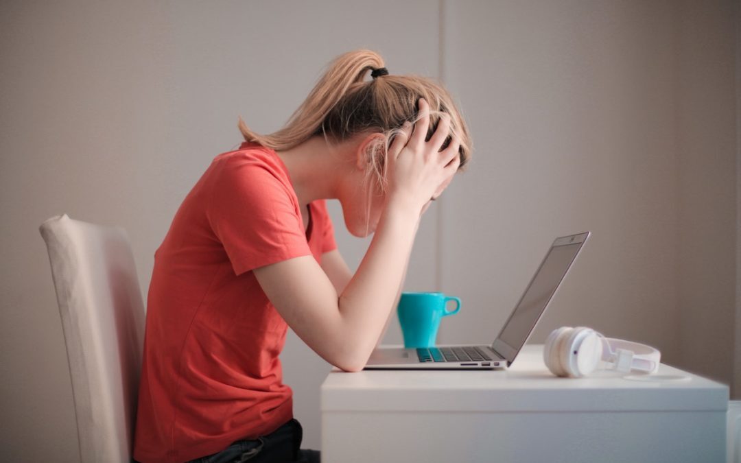 woman sitting at computer stressed